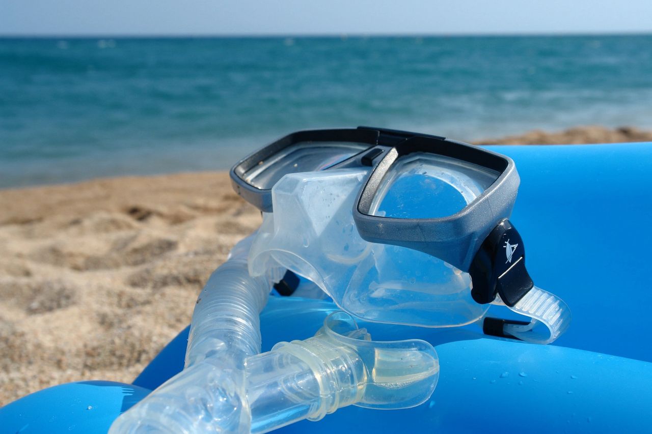 mask and snorkel set laying on the beach