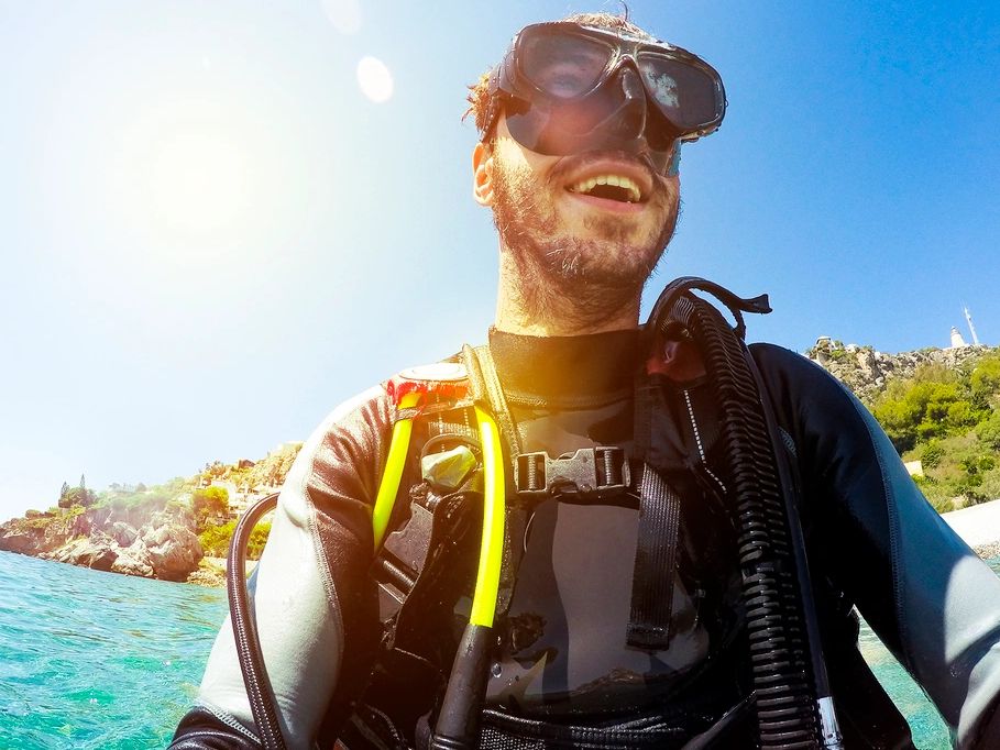 man in scuba gear standing on the dive boat